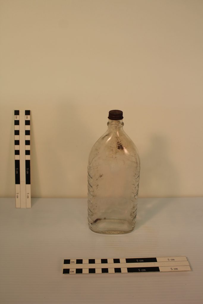 Parson's Ammonia Company glass bottle. The decoration along the sides was made to help grip the bottle when used with wet or soapy hands. Calamity Camp, BLM Collection.