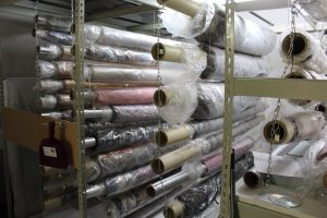 Textiles in storage at the Museum of the West. Things like rugs and blankets are rolled and hung to protect the object and save space.
