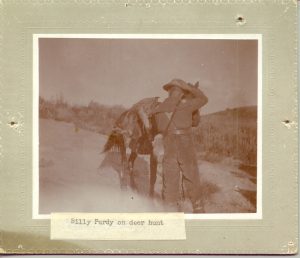 Bill Purdy on a deer hunt. Purdy, with his back to the camera, is leading his horse with a deer across the saddle. Photo # 1979.0023 #029, Museums of Western Colorado.