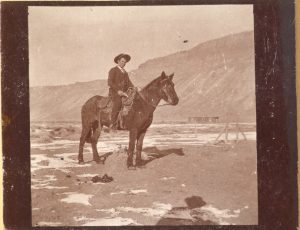 A man on horseback in 1894 with the Bookcliffs in the background. Photo # 1979.0023 #169, Museums of Western Colorado.