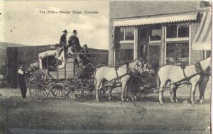 A postcard showing a stagecoach pulled by four horses. The postcard is addressed to Mrs. E. Lewis in 1910. Photo # 1979.0023 #157, Museums of Western Colorado.